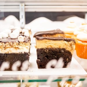 Delicious squares in a display case by Sugar Mama's Bake Shoppe